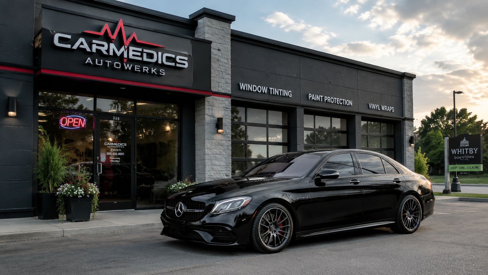 Best Car Window Tinting: An Ontario Driver's Guide 2026 3 A sleek black Mercedes luxury sedan parked in front of the Carmedics Autowerks shop for services.