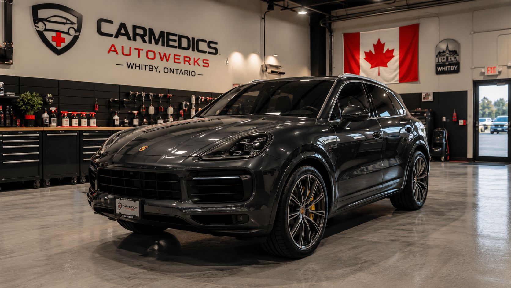Paint Protection Film Advantages and Disadvantages 21 A sleek, dark gray Porsche luxury SUV parked inside a professional detailing shop in Whitby, Ontario.