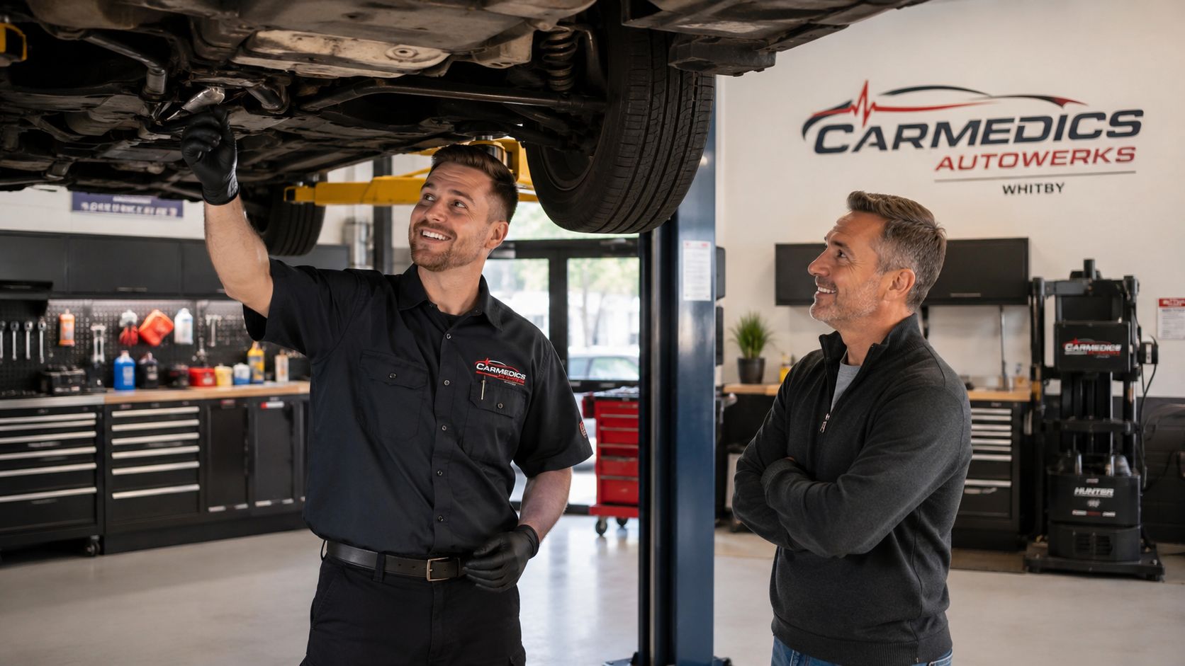 Transmission Fluid Service: A Complete Guide for 2026 8 A professional mechanic explains a car repair to a customer while standing under a lifted vehicle.